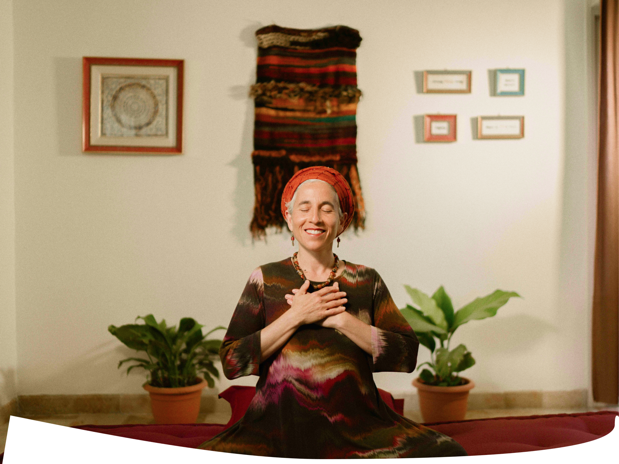 Chana Mason seated in meditation with hands on heart